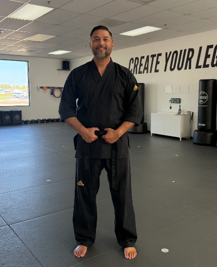 Master Romeo Gregory in his black uniform standing on the mat at Legacy Martial Arts in Oxnard